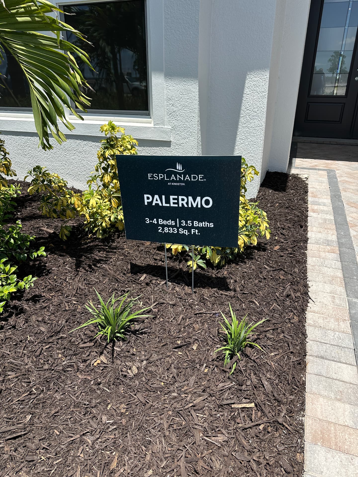 Esplanade at Kingston Palermo model home sign in Estero, FL listing 3 to 4 beds, 3.5 baths and 2,833 sq ft, photographed August 2026