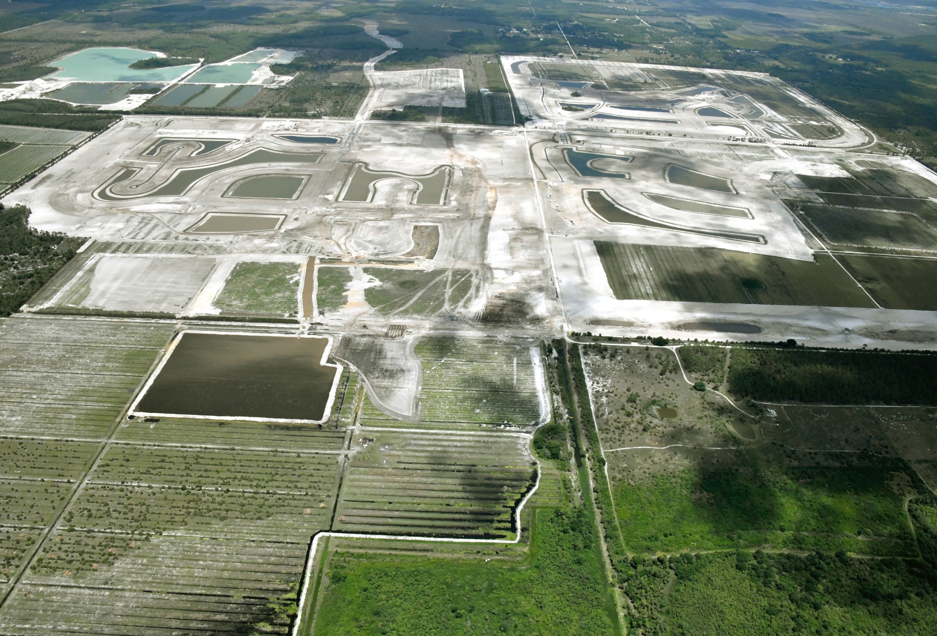Aerial photograph of Kingston lakes, preserve land and early construction in Estero, Florida