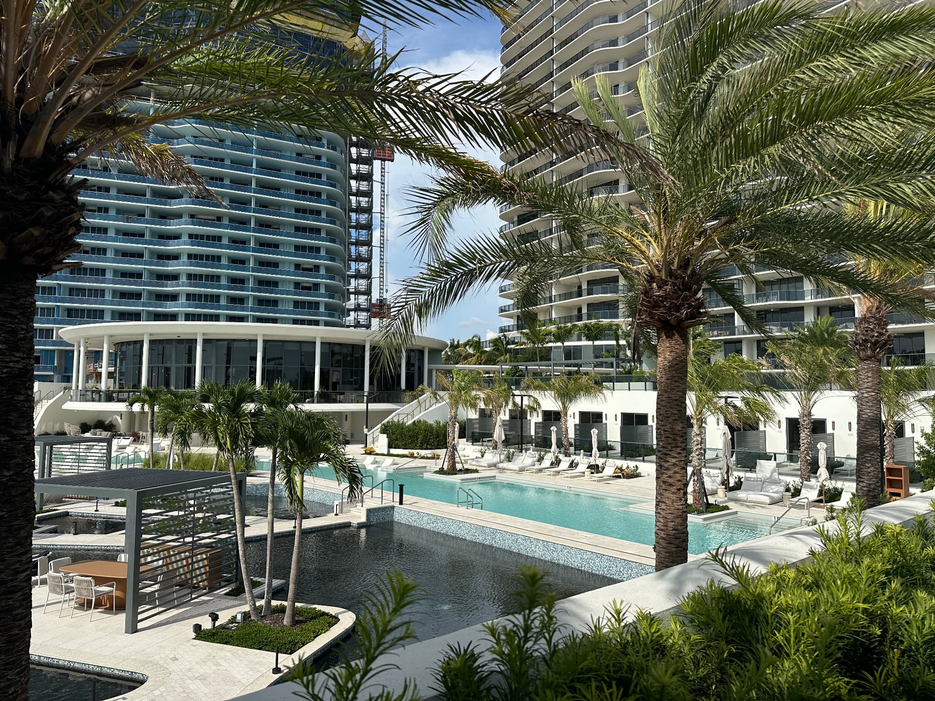 Amenity pool, sun deck, and clubhouse pavilion at The Ritz-Carlton Residences, Estero Bay, August 2026
