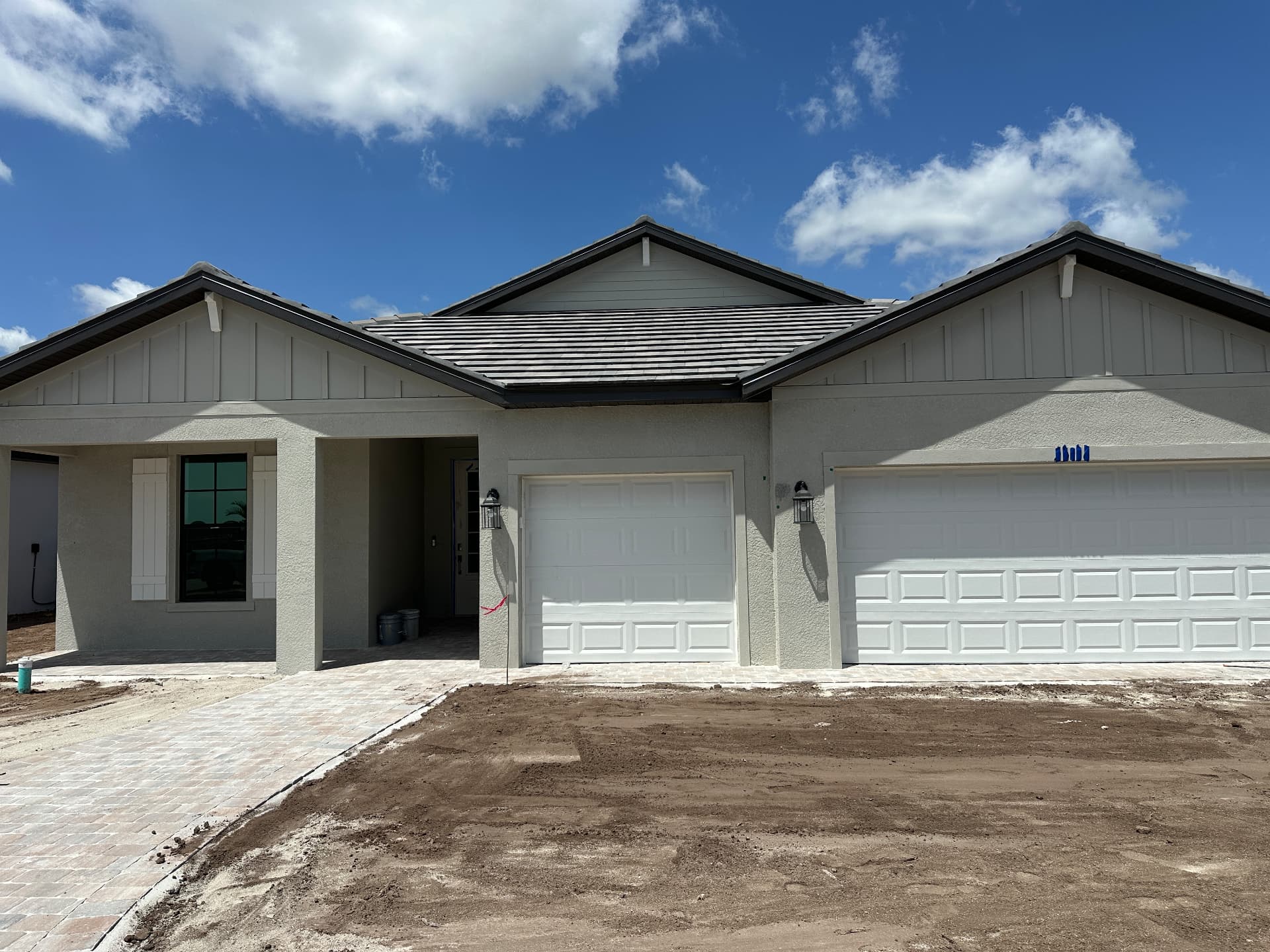 Single-story new construction home with three-car garage configuration in Kingston, Estero, Florida — August 2026
