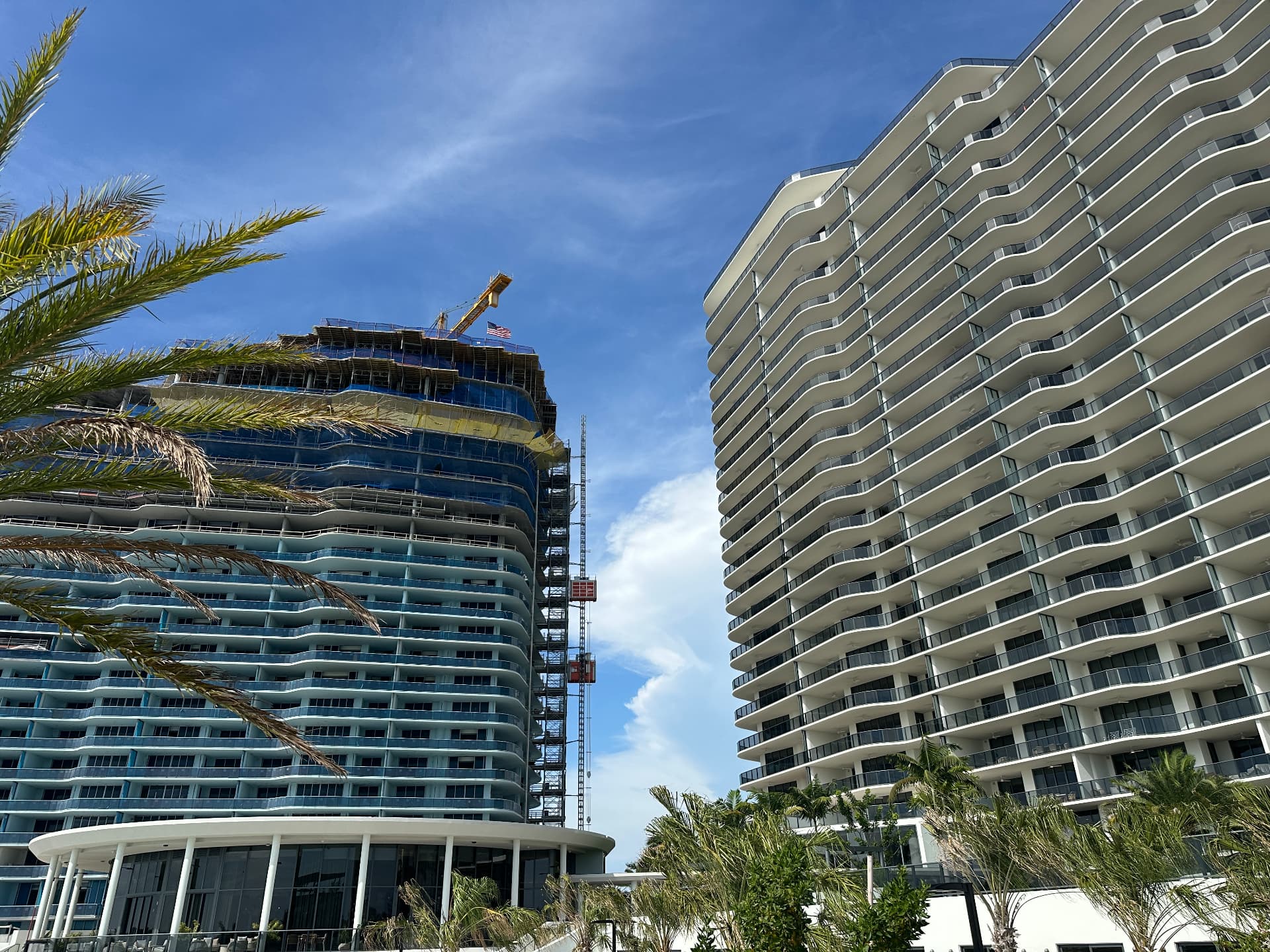North tower under construction beside the completed south tower at The Ritz-Carlton Residences, Estero Bay, August 2026
