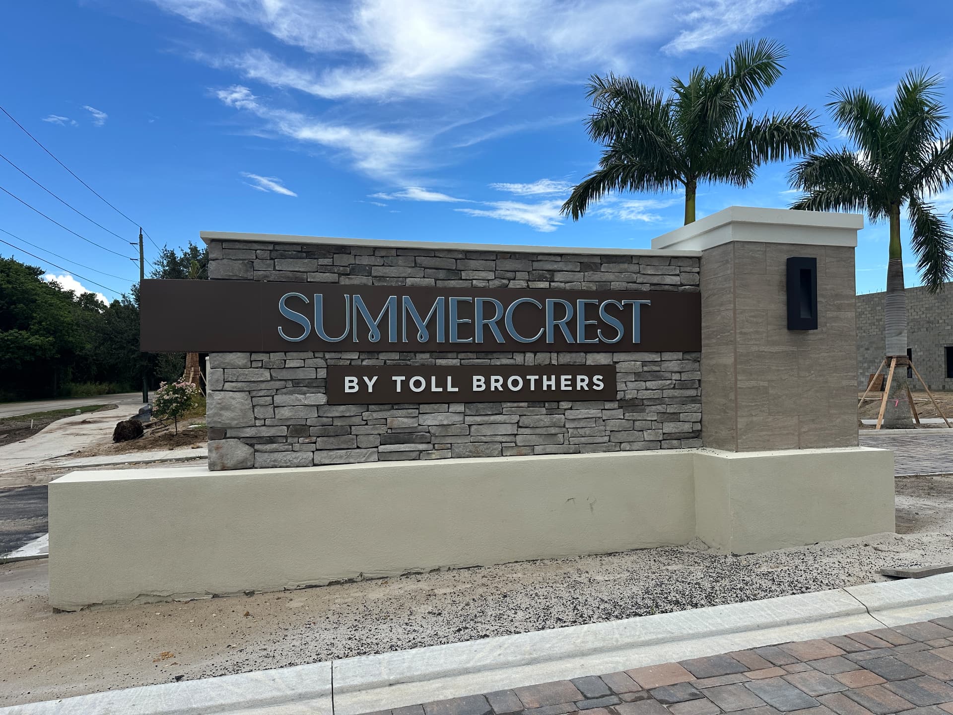Summercrest by Toll Brothers stone entrance monument sign at Corkscrew Road and Sandy Lane in Estero, Florida, photographed September 6, 2026