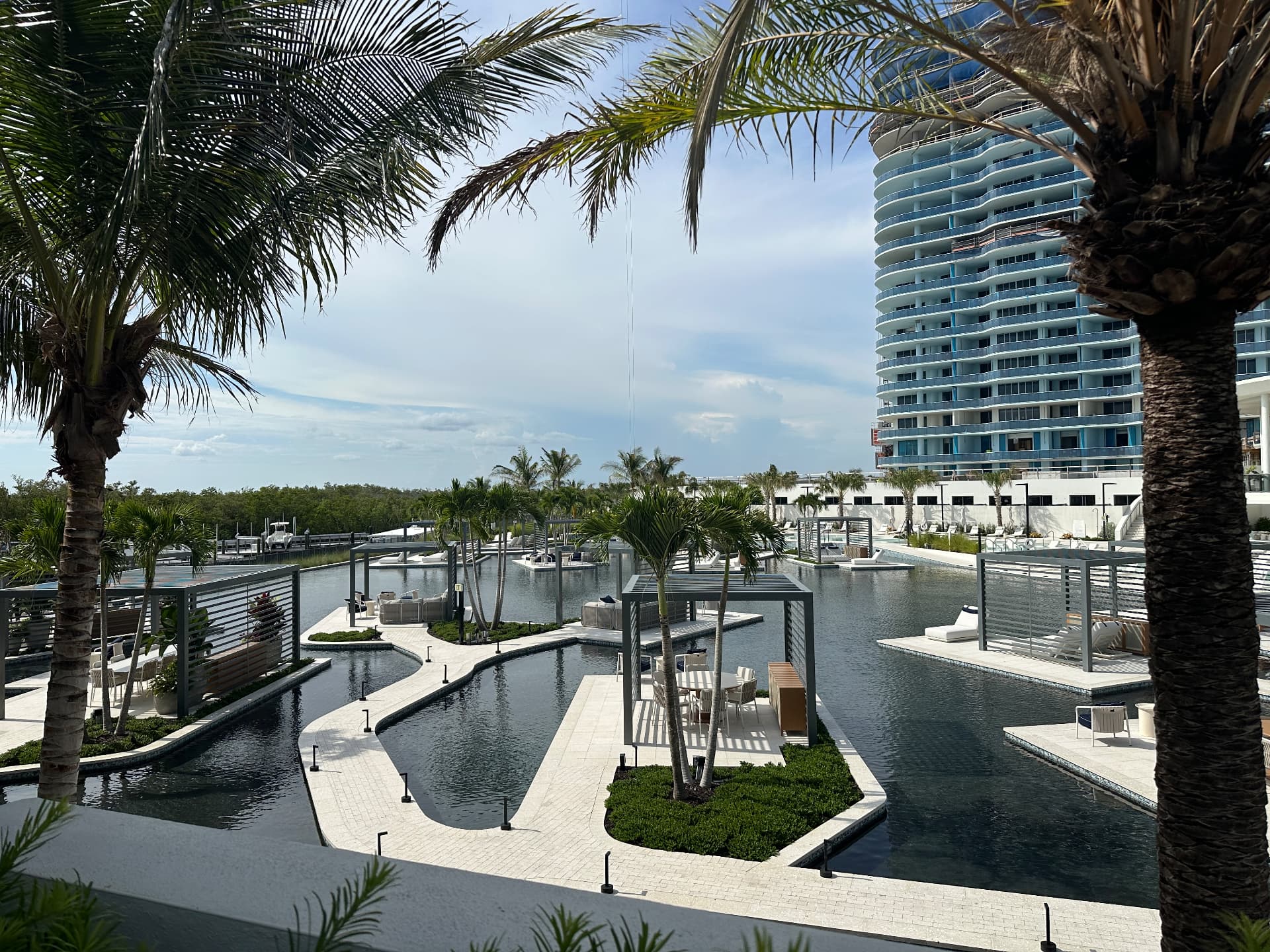Finished resort pool deck and marina basin at The Ritz-Carlton Residences, Estero Bay, August 2026