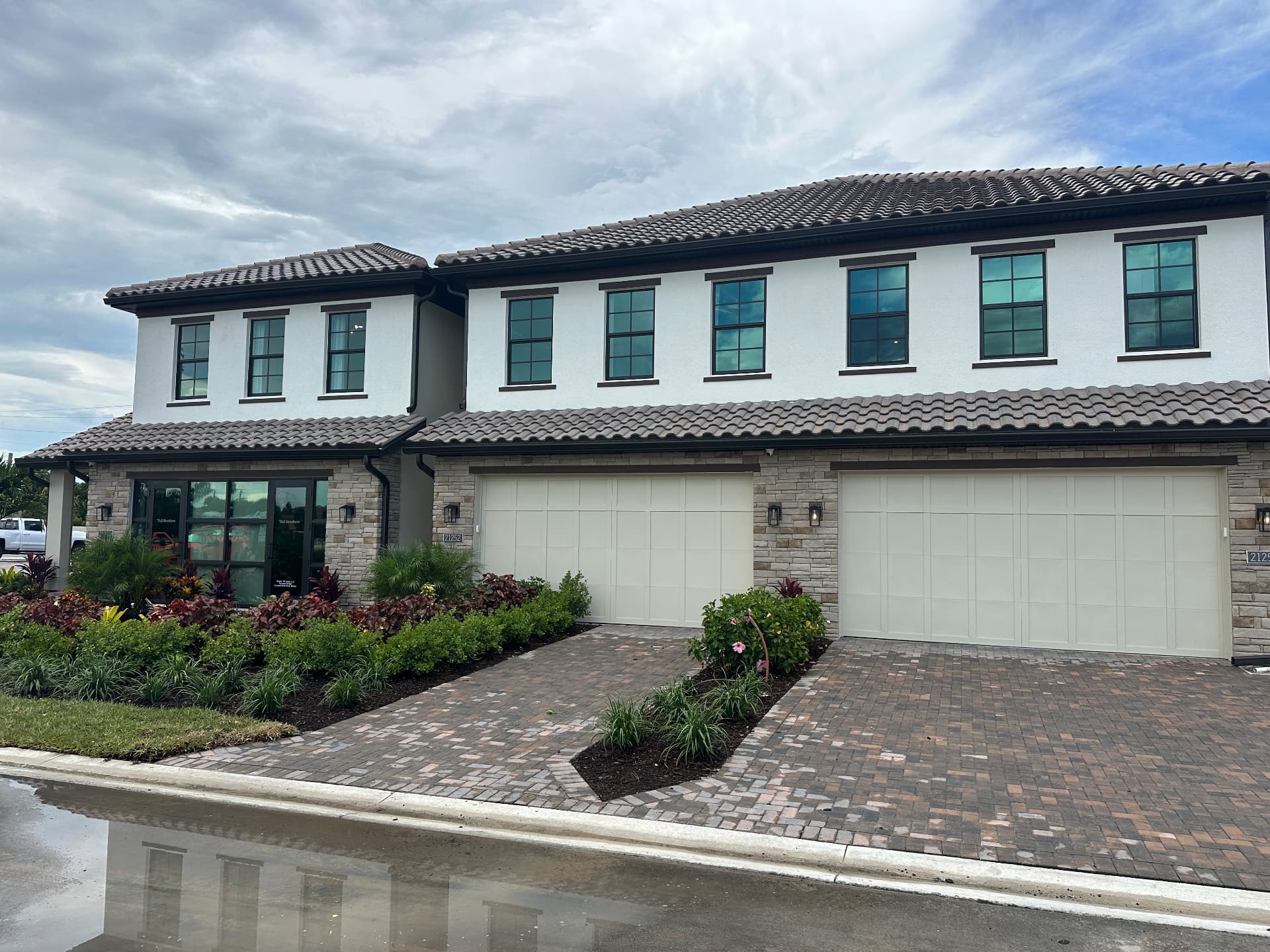Summercrest by Toll Brothers townhome model home exterior in Estero, Florida showing tile roof and two-car garages, photographed September 6, 2026